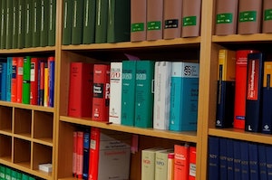 Orange County Criminal Defense Angled Close Up of a Book Shelf with Assorted Law Books on Each Shelf