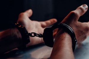 Close Up of a Person’s Hands in Handcuffs