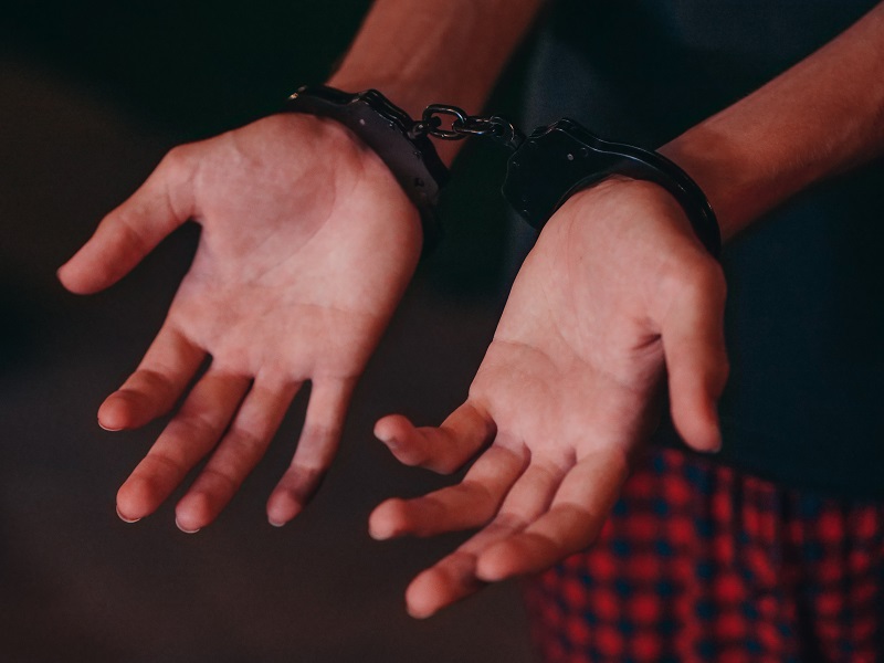Theft Crimes Attorney in Los Angeles County Close Up of a Person putting Their hands Out with Handcuffs on Their Wrists