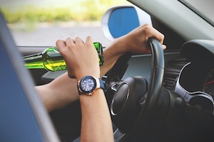 DUI Attorney in Los Angeles County View of Person Drinking Beer While Sitting in a Driver Seat in a Car