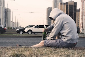 DUI Attorney in Los Angeles County Person Sitting on the Side of the Road Drinking Alcohol